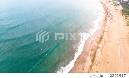 Aerial view of sandy beach with tourists swimming  40295957