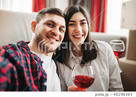 Love couple watches movie and drinks red wine 40296365
