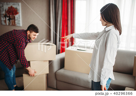 Happy couple arrange cardboard boxes on a room 40296366