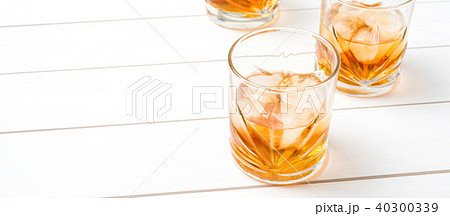 Whiskey glasses on white wooden table. Close up 40300339