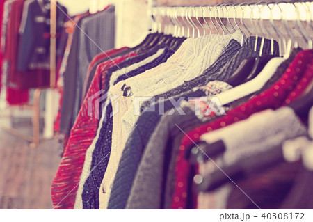 Colorful clothes hanging on hangers in the store Colorful clothes hanging on hangers in the store 40308172