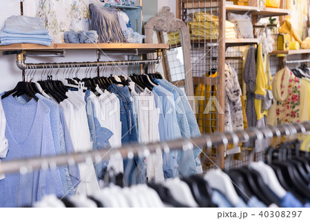 Different colored clothes in the modern shopping centre 40308297