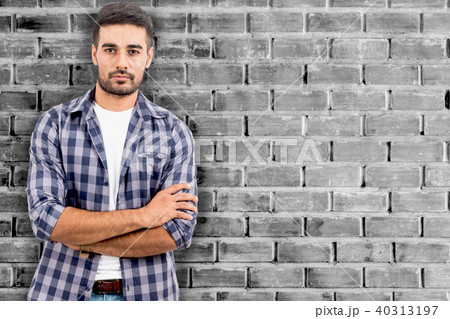 Portrait handsome young man standing on wall 40313197