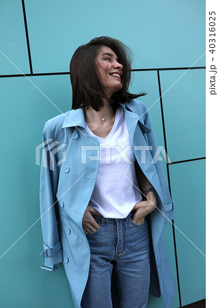 Attractive young woman on a turquoise background. 40316025