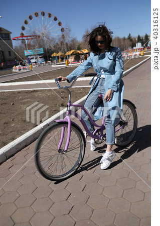 Stylish young woman riding a bicycle. 40316125
