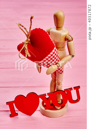 Wooden dummy mannequin in love holding heart. 40317872