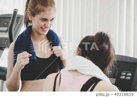 Fitness trainer encouraging friend to train harder Fitness trainer encouraging friend to train harder 40318659