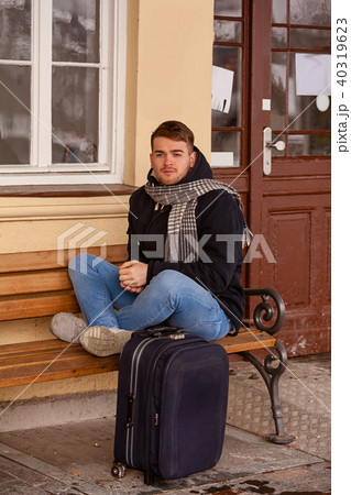 Young man sitting in winter on a bench 40319623