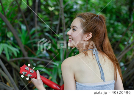 Music Concepts. Asian girls playing Ukulele. Asian women relaxin Music Concepts. Asian girls playing Ukulele. Asian women relaxin 40320496