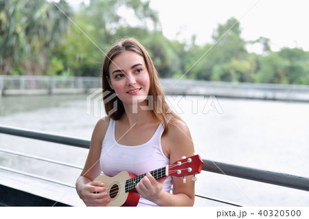 Music Concepts. beautiful girls playing Ukulele. women relaxing 40320500