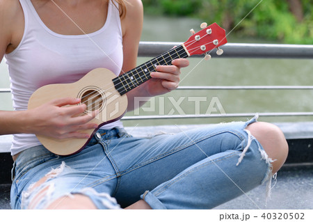 Music Concepts. beautiful girls playing Ukulele. women relaxing Music Concepts. beautiful girls playing Ukulele. women relaxing 40320502