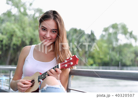 Music Concepts. beautiful girls playing Ukulele. women relaxing Music Concepts. beautiful girls playing Ukulele. women relaxing 40320507