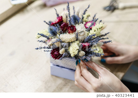 flower master class. Close-up of womans hand. beautiful mini bouquet lavender and dry flowers on 40323441