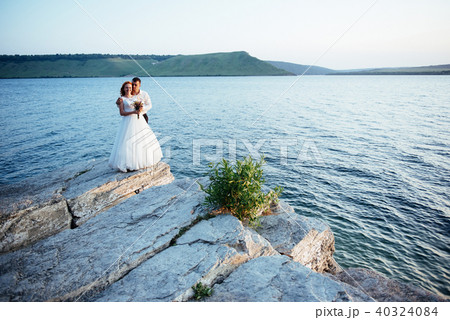 beautiful gorgeous blonde bride and stylish groom on rocks 40324084