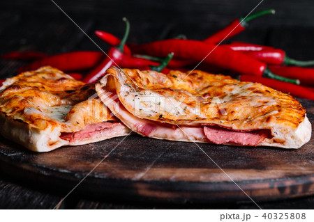 Cutted Spicy Calzone - Stuffed Pizza with chilli 40325808