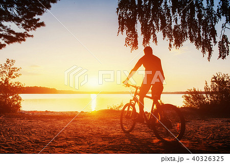 boy on a bicycle at sunset 40326325