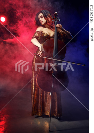 The cellist girl performs on stage. 40326712