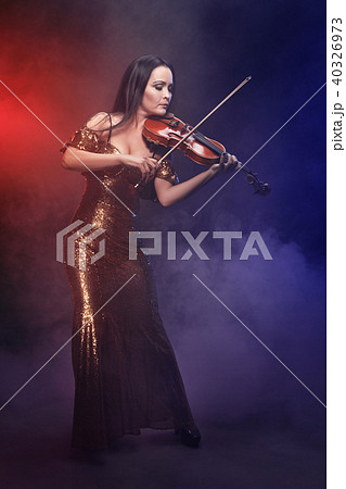 Violinist girl performs on stage. 40326973