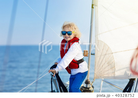 Kids sail on yacht in sea. Child sailing on boat. Kids sail on yacht in sea. Child sailing on boat. 40328752