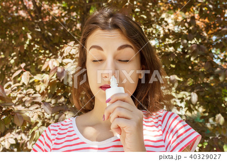 Girl drips blocked nose from allergy. 40329027