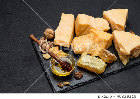 pieces of parmesan or parmigiano cheese and honey pieces of parmesan or parmigiano cheese and honey 40329219