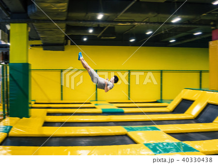 trampoline jumper performs acrobatic exercises on the trampoline 40330438