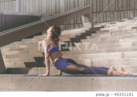 Fitness woman doing yoga urban practice outdoors. Healthy young girl practising yoga on seaside 40331191