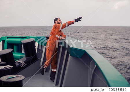 The fisherman throws a hook on a ship for catching tuna fish. Fishing at sea. 40333612