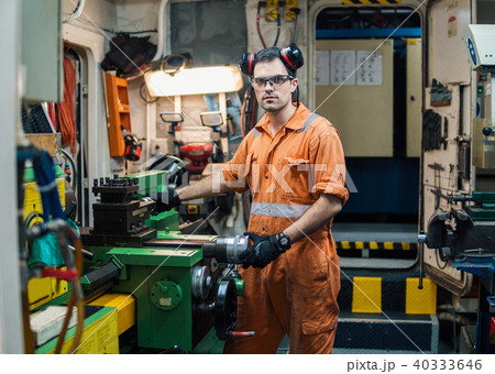 Marine engineer working in ship's workshop in engine control room 40333646