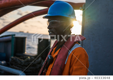 Seaman AB or Bosun on deck of vessel or ship , wearing PPE 40333648