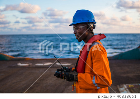 Seaman AB or Bosun on deck of vessel or ship , wearing PPE 40333651