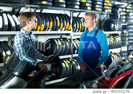 Technician standing with customer in shop Technician standing with customer in shop 40334276