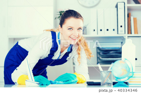 Smiling woman cleaning room 40334346