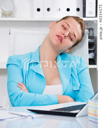 Woman worker is sleeping at work after putting the reports Woman worker is sleeping at work after putting the reports 40334373