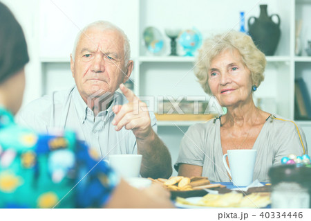 Serious mature parents having unpleasant talk with daughter 40334446
