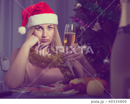 Girl is bored and drinking champagne in New Year night 40334800