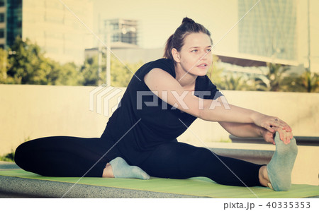Young woman doing exercises outdoors Young woman doing exercises outdoors 40335353
