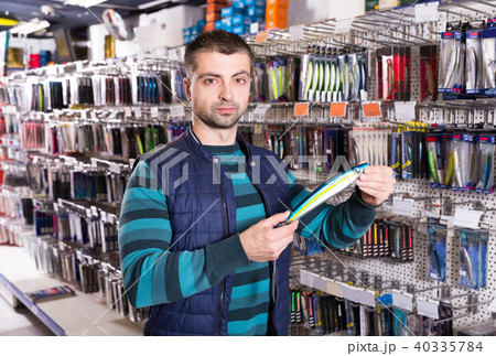 male customer selecting fishing lures male customer selecting fishing lures 40335784
