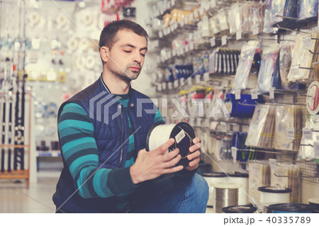 Fisherman customer looking fishing line for rod Fisherman customer looking fishing line for rod 40335789