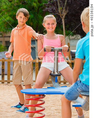 Company of kids are teetering on the swing 40336194