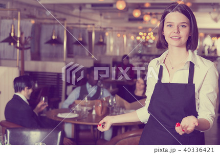Portrait of smiling female waiter who is standing Portrait of smiling female waiter who is standing 40336421