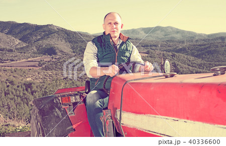 Farmer sitting in tractor 40336600