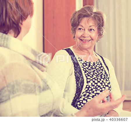 Happy senior women having chat at home Happy senior women having chat at home 40336607