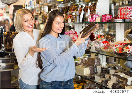 Happy women buying chocolate bars .の写真素材 [40336677] - PIXTA