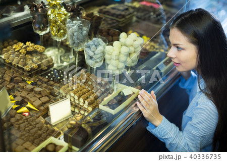 Happy girl buying chocolate Happy girl buying chocolate 40336735
