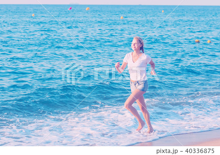 Sportswoman is jogging on the beach 40336875