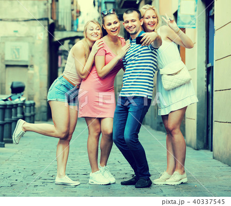 Smiling persons taking self picture with mobile phone Smiling persons taking self picture with mobile phone 40337545