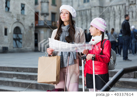 Cheerful girl and woman with map in scarf 40337614