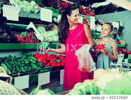 Woman and girl taking paprika Woman and girl taking paprika 40337680