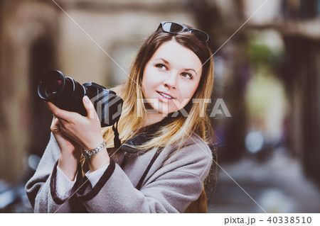 Young woman looking curious and taking pictures 40338510